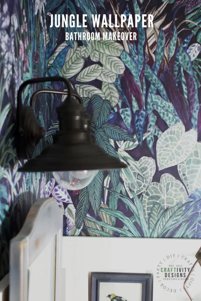 Jungle Wallpaper Bathroom Makeover with Black Wall Sconces, Gray Mirror, and Board and Batten Trimwork
