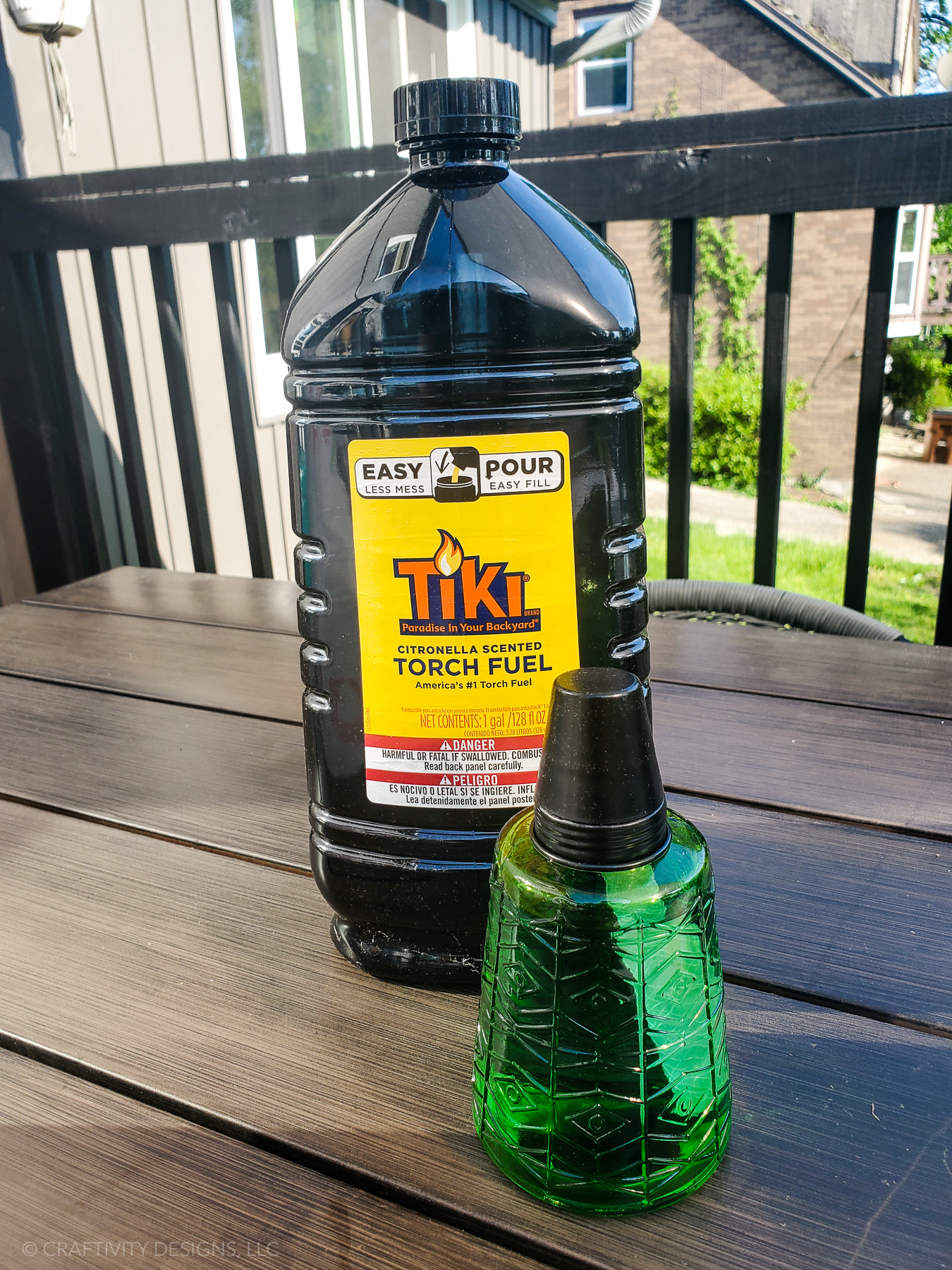 green glass tabletop tiki torch and citronella oil