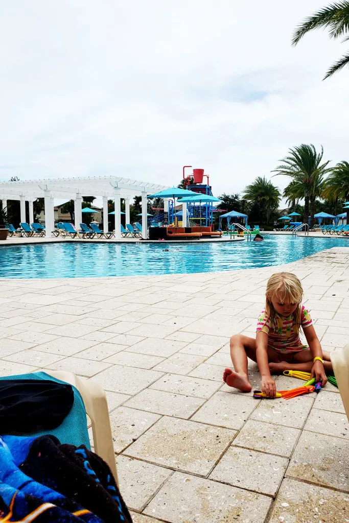 Child playing by the pool at Windsor at Westside Clubhouse