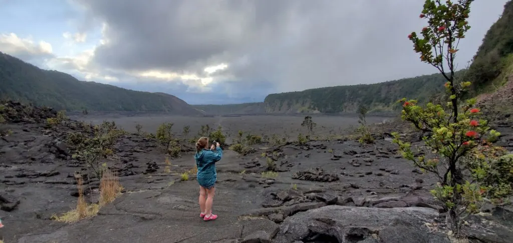 Woman taking photo in Kīlauea Iki Crater at Hawaii Volcanoes National Park