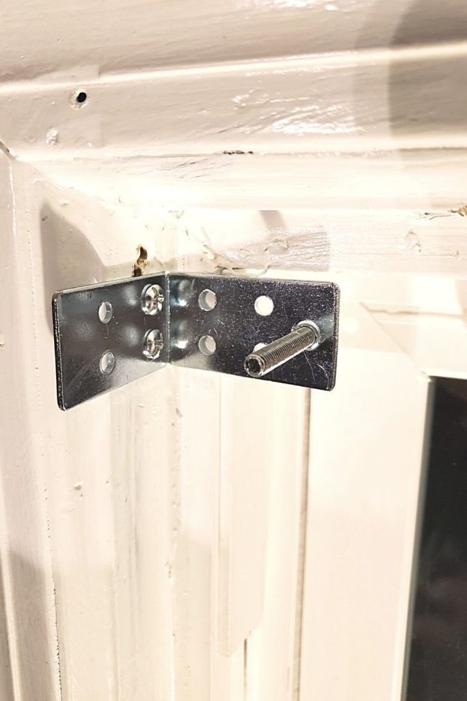attach brackets to window trim with screws