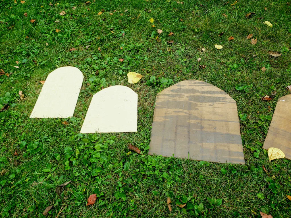 cut scraps of wood into tombstone shapes