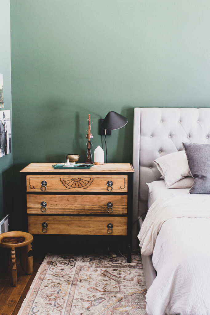 dark green master bedroom with gray and cream neutrals and eclectic decor