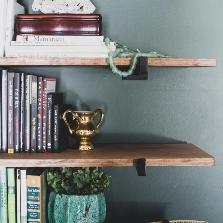 Global eclectic decor on heavy duty wall shelves in green master bedroom, heavy duty shelf brackets