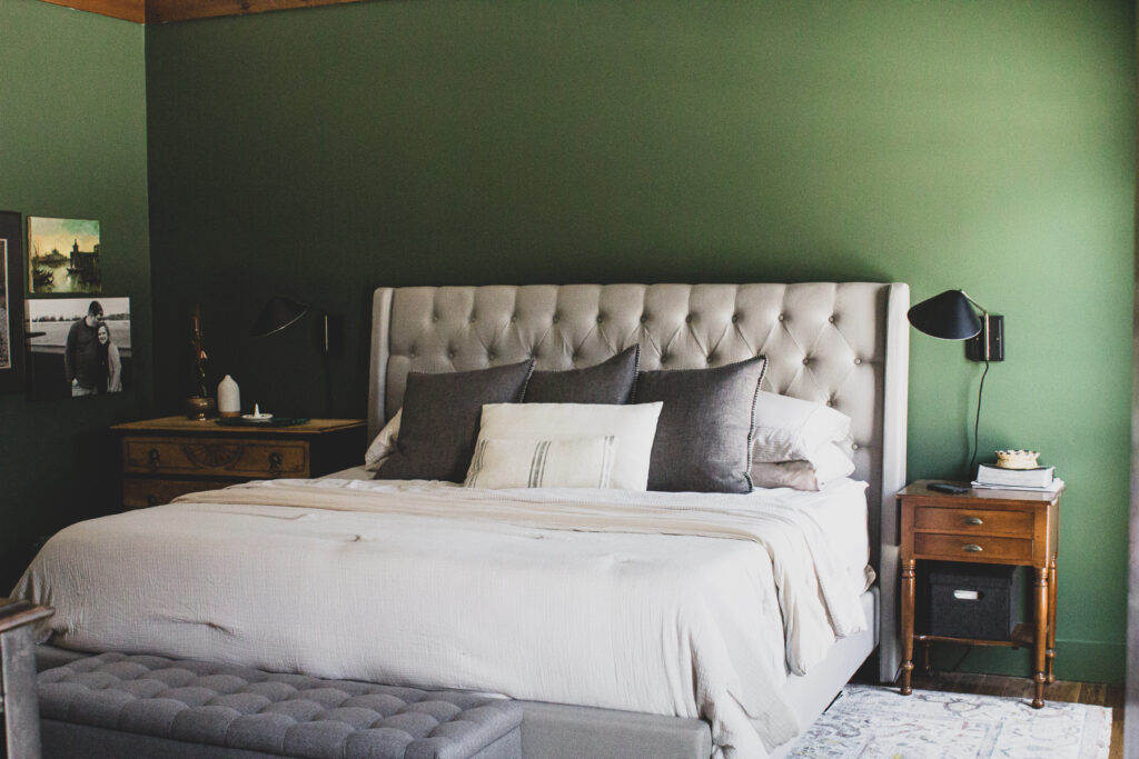dark green bedroom walls with neutral gray and cream furniture
