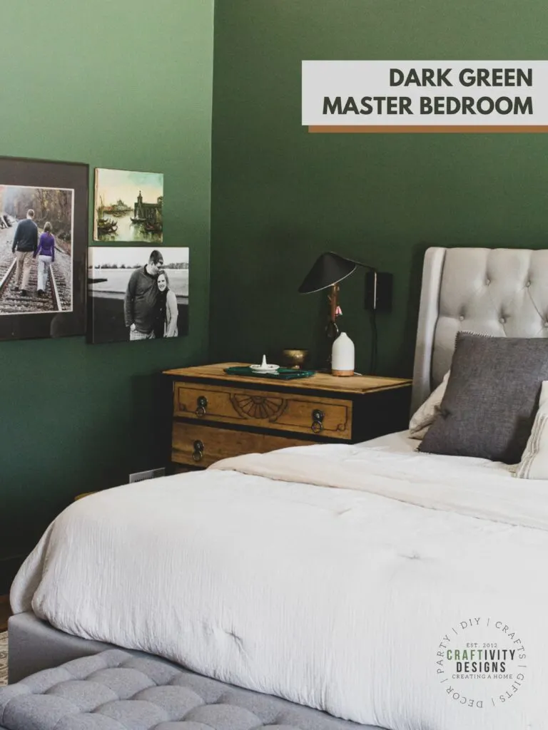 dark green bedroom walls with neutral gray and wood furniture