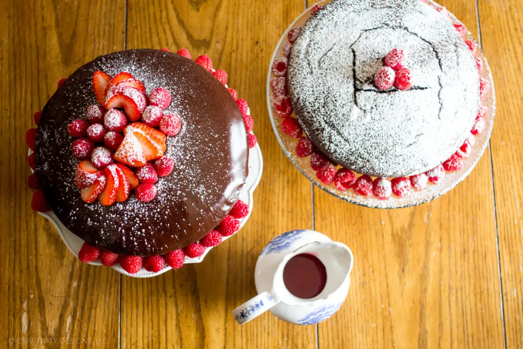 strawberry and raspberry cakes with powdered sugar and chocolate ganache