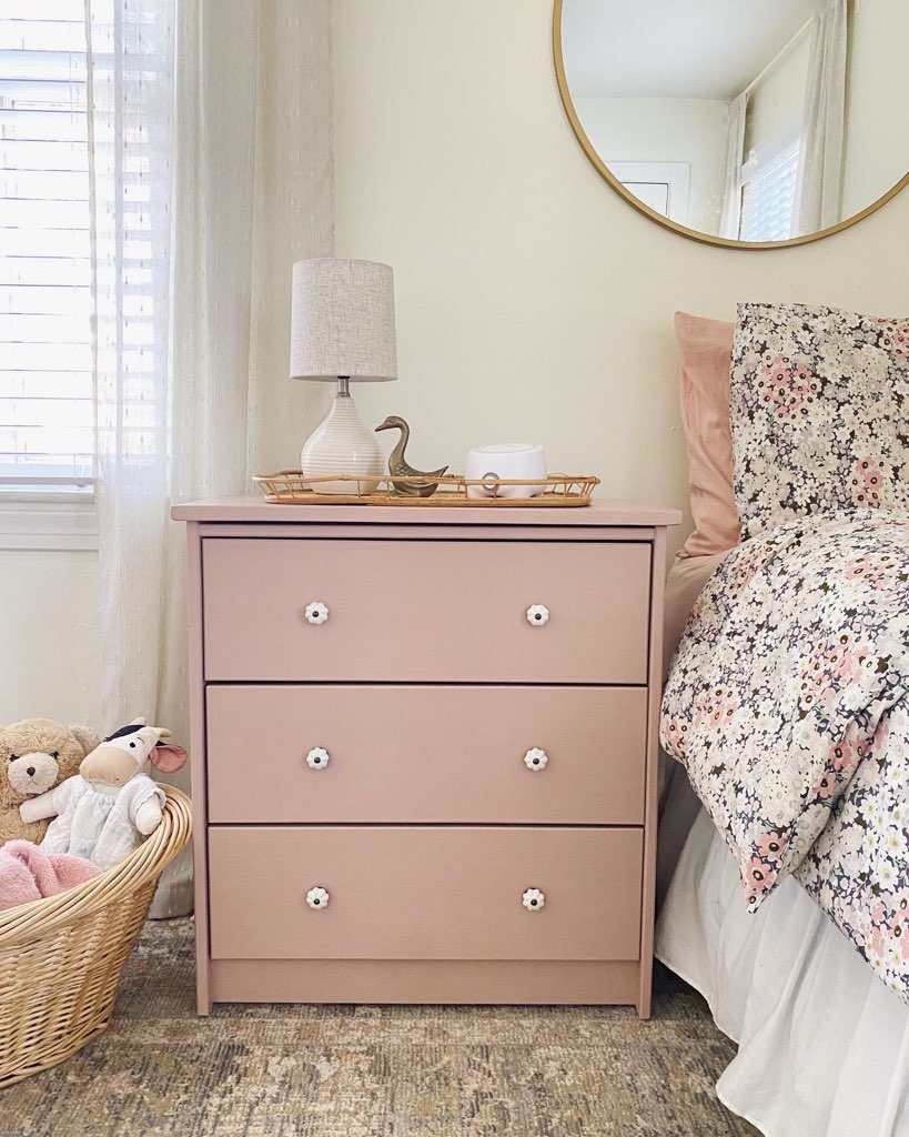 pink dresser as a nightstand in a girl's bedroom