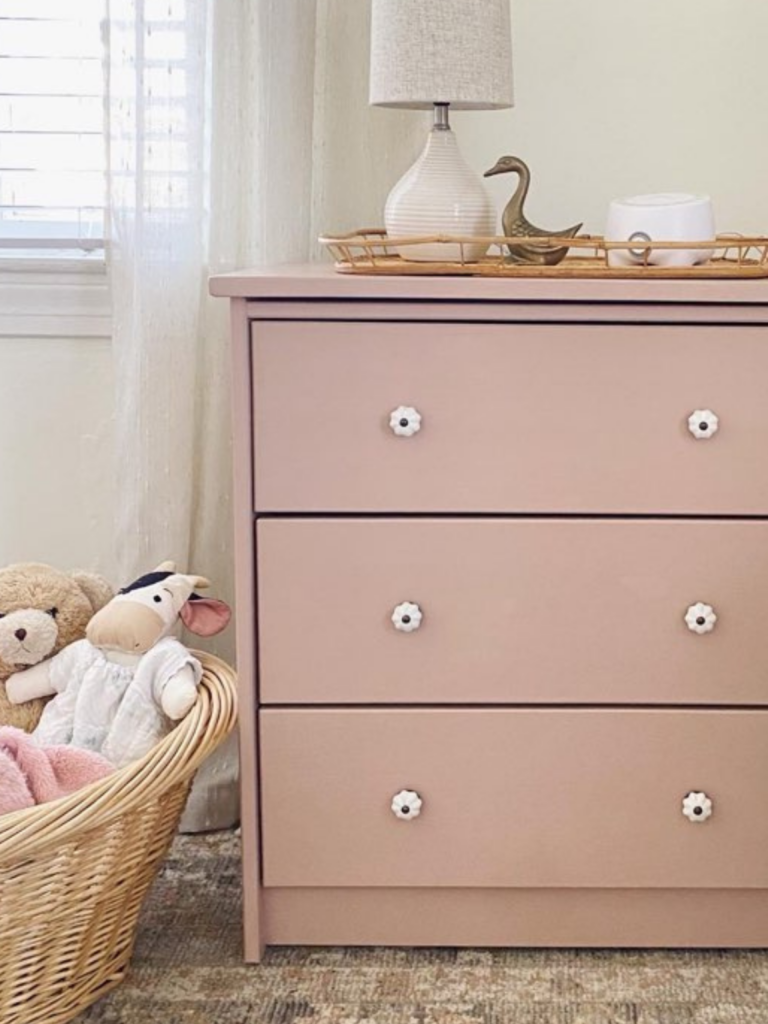 diy pink dresser as a nightstand in a girl's bedroom