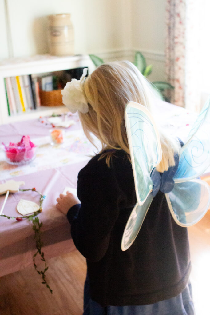 child with fairy wings at fairy birthday party