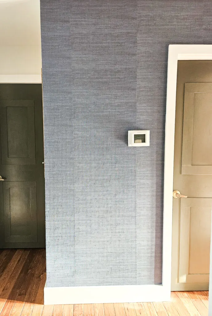 blue grasscloth accent wall, vinyl peel-and-stick faux grasscloth in a hallway