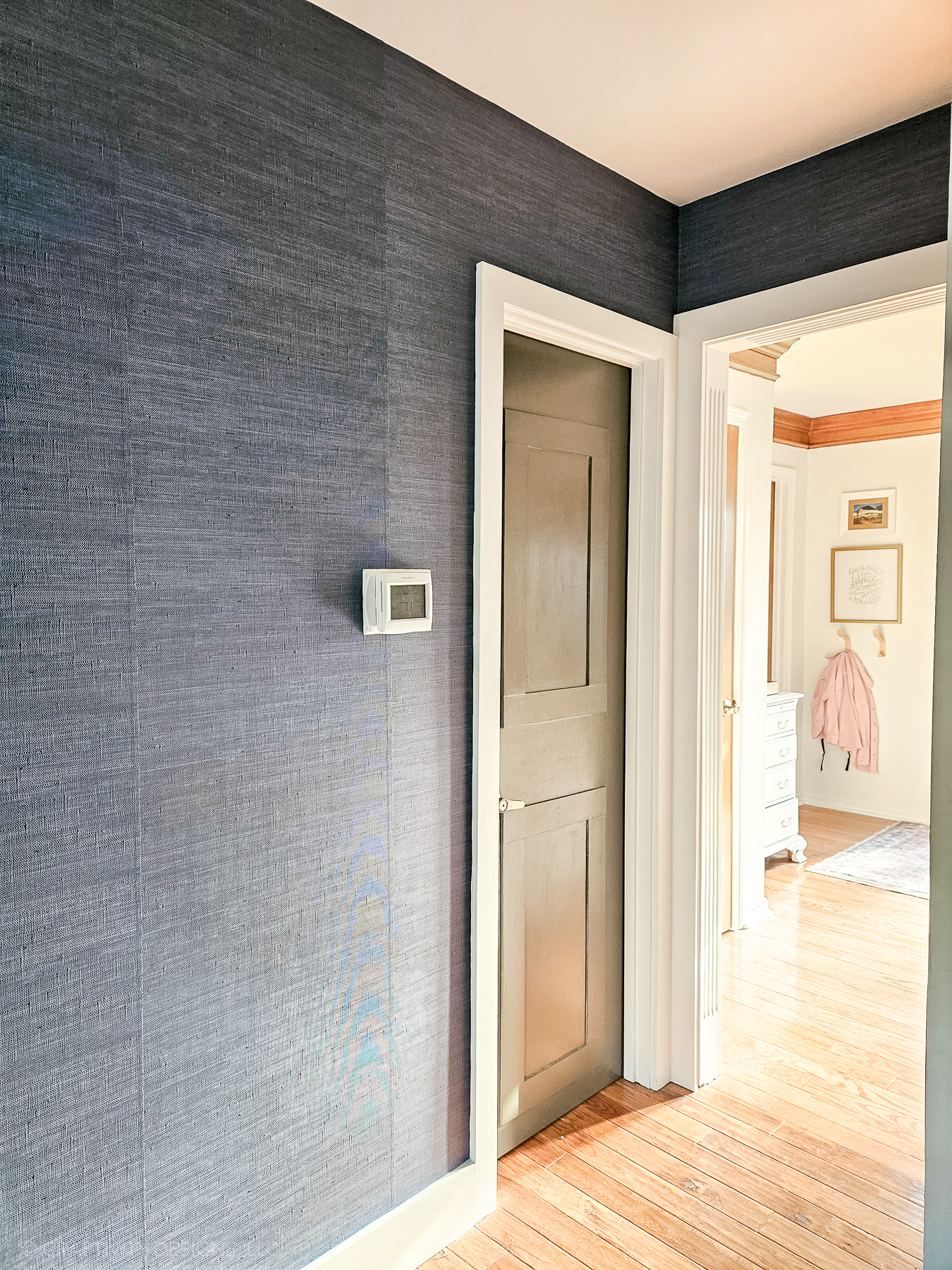 blue grasscloth accent wall, vinyl peel-and-stick faux grasscloth in a hallway