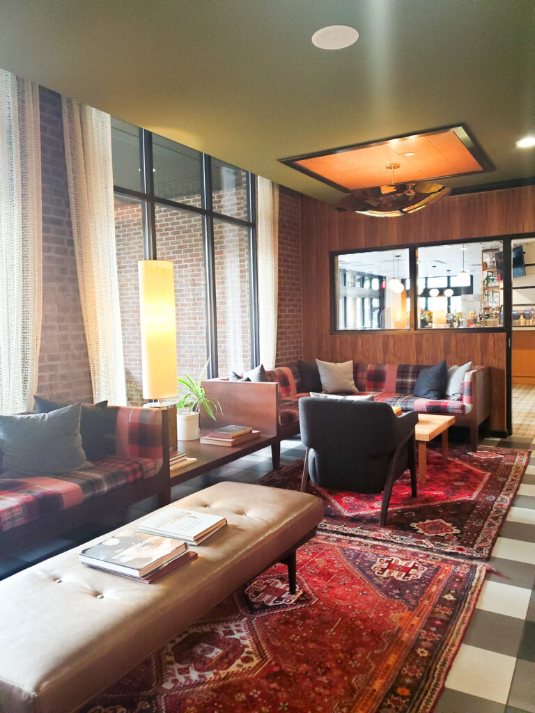 green ceiling, black and white check flooring with oriental rugs, mid-century modern furniture