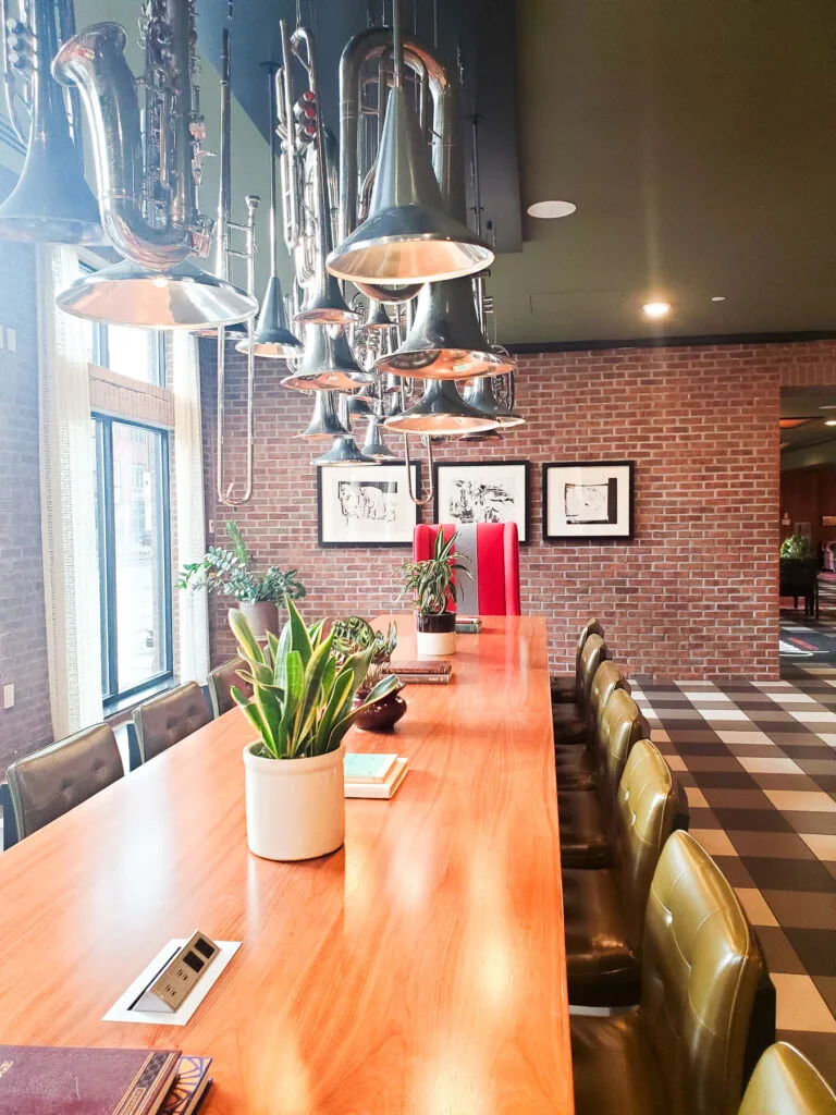 graduate columbus lobby, long study table, black and white check floor, trumpet and trombone chandelier